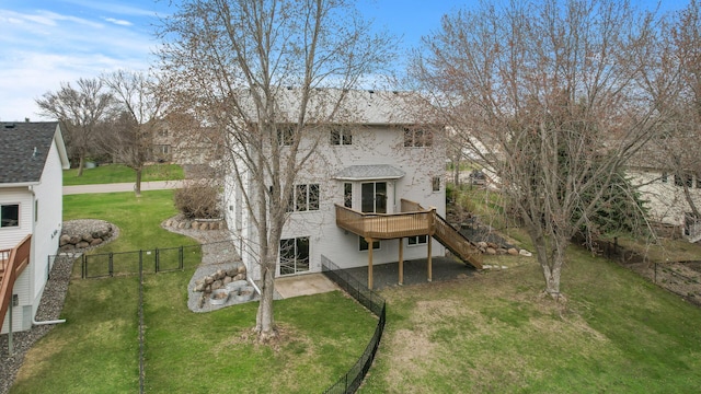 back of property featuring a lawn, fence private yard, stairs, and a wooden deck