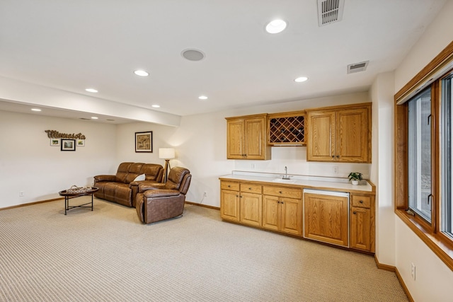 living area featuring light colored carpet, visible vents, baseboards, recessed lighting, and indoor wet bar