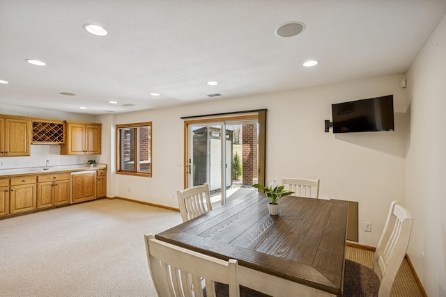 dining space with recessed lighting, wet bar, light carpet, baseboards, and visible vents