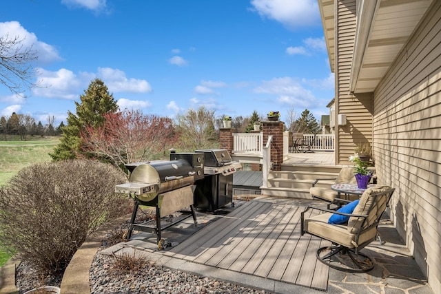 wooden deck with a grill