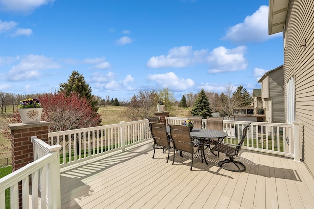 wooden terrace featuring outdoor dining area
