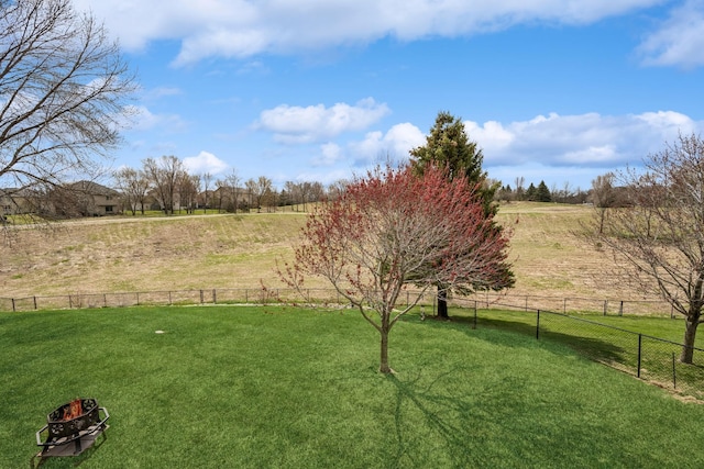 view of yard featuring fence and a rural view