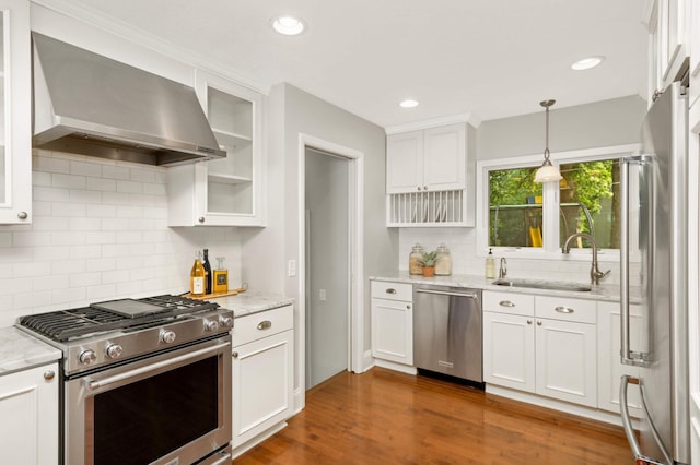 1310 Vine Pl, Orono, MN 55364 - kitchen with appliances with stainless steel finishes, wall chimney exhaust hood, a sink, white cabinets, and recessed lighting