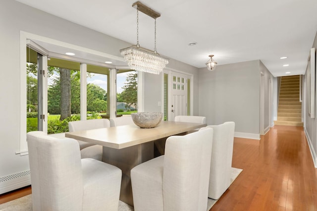 1310 Vine Pl, Orono, MN 55364 - dining space with stairs, a chandelier, recessed lighting, baseboards, and light wood-style flooring