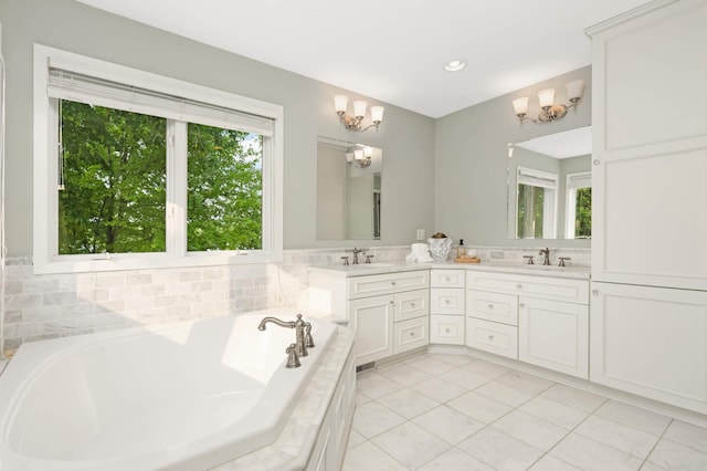 1310 Vine Pl, Orono, MN 55364 - bathroom with tile patterned flooring, a garden tub, double vanity, a chandelier, and recessed lighting