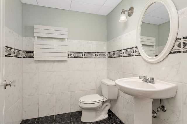 1310 Vine Pl, Orono, MN 55364 - bathroom with toilet, tile walls, tile patterned flooring, and a wainscoted wall