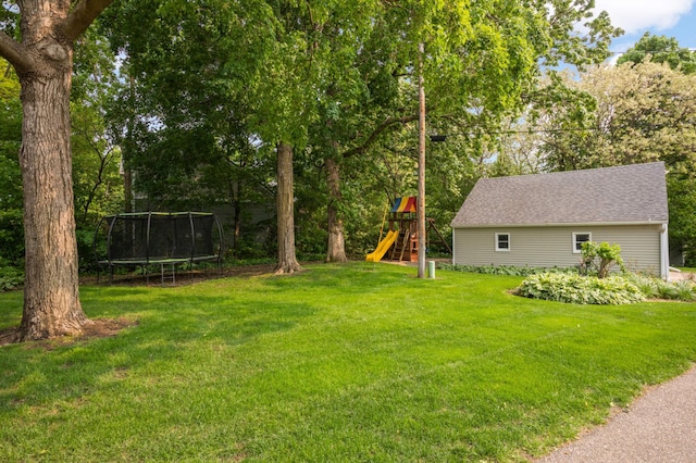 1310 Vine Pl, Orono, MN 55364 - view of grassy yard with a playground, a trampoline, and view of scattered trees