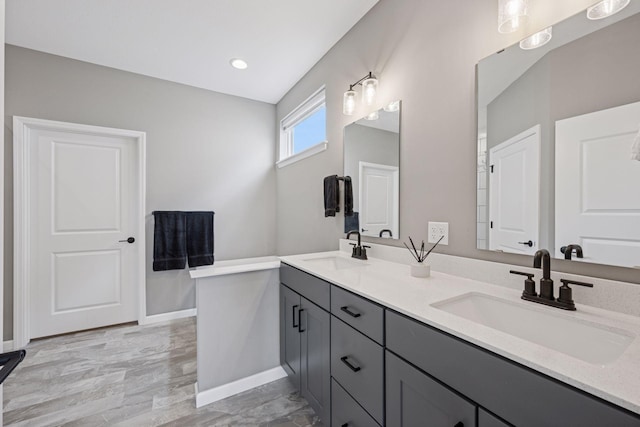 19477 102nd Pl, Corcoran, MN 55374 - bathroom featuring double vanity, wood finished floors, and recessed lighting