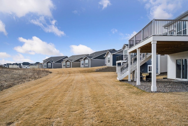 19477 102nd Pl, Corcoran, MN 55374 - view of green lawn with a residential view, a wooden deck, and stairs
