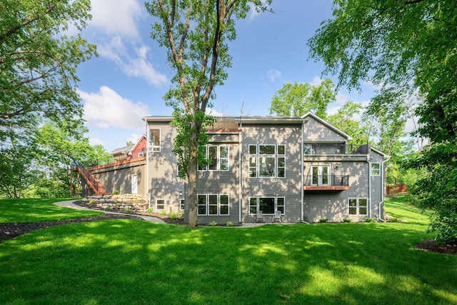 18837 Ogden St NW, Elk River, MN 55330 - rear view of property with a lawn and a balcony