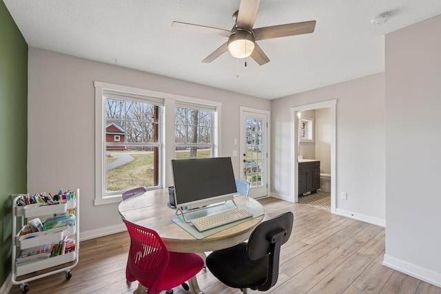 18837 Ogden St NW, Elk River, MN 55330 - home office with light wood-style flooring, ceiling fan, and baseboards