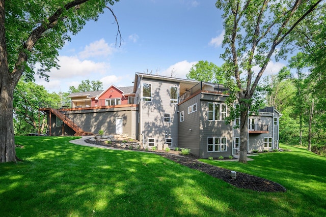 18837 Ogden St NW, Elk River, MN 55330 - back of property with a balcony, a yard, and stairway