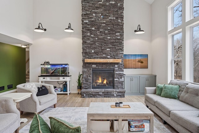 18837 Ogden St NW, Elk River, MN 55330 - living area featuring a towering ceiling, wood finished floors, a fireplace, and stairway