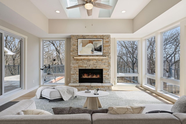 18837 Ogden St NW, Elk River, MN 55330 - living room featuring plenty of natural light, wood finished floors, a skylight, and a fireplace