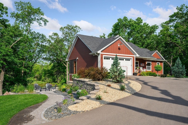 18837 Ogden St NW, Elk River, MN 55330 - view of front of house with an attached garage, asphalt driveway, roof with shingles, and board and batten siding
