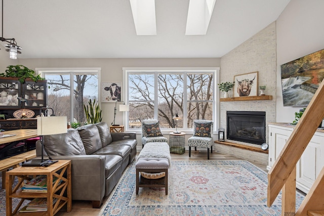 18837 Ogden St NW, Elk River, MN 55330 - living room with wood finished floors, a brick fireplace, a skylight, and vaulted ceiling