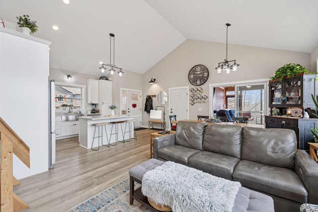 18837 Ogden St NW, Elk River, MN 55330 - living room with high vaulted ceiling, a chandelier, light wood-type flooring, and recessed lighting