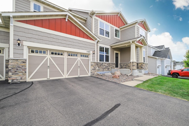 15485 Jersey Ave S, Savage, MN 55378 - view of front of home with stone siding, board and batten siding, asphalt driveway, and a garage