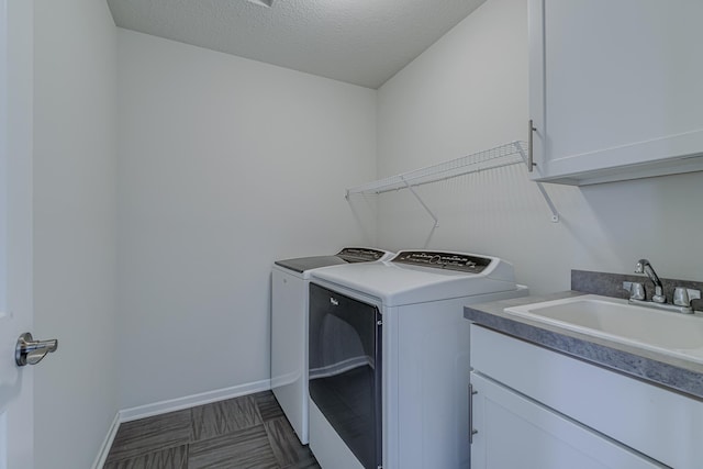 15485 Jersey Ave S, Savage, MN 55378 - washroom with washer and dryer, cabinet space, baseboards, and a textured ceiling