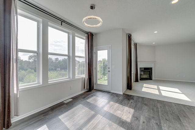 15485 Jersey Ave S, Savage, MN 55378 - unfurnished living room with a glass covered fireplace, baseboards, wood finished floors, and recessed lighting