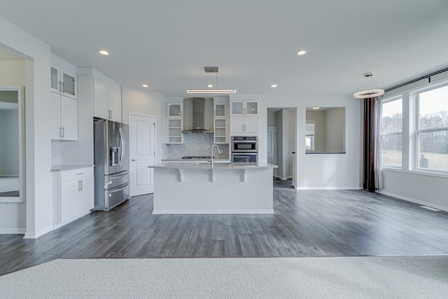 15485 Jersey Ave S, Savage, MN 55378 - kitchen featuring stainless steel appliances, wall chimney range hood, light countertops, dark wood-style floors, and backsplash