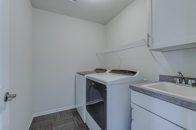 15485 Jersey Ave S, Savage, MN 55378 - laundry room featuring separate washer and dryer, cabinet space, and a textured ceiling