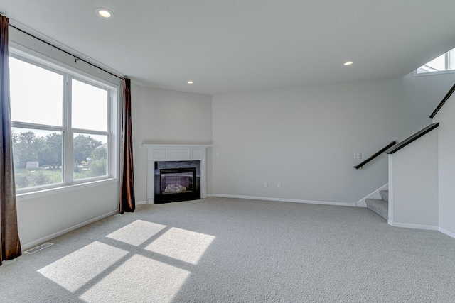 15485 Jersey Ave S, Savage, MN 55378 - unfurnished living room with light colored carpet, recessed lighting, a premium fireplace, and stairs