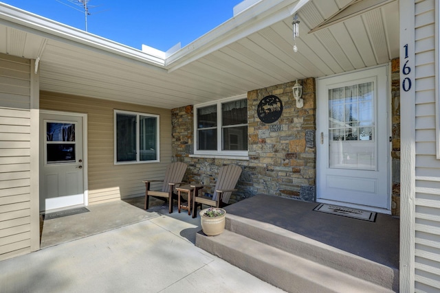 property entrance featuring stone siding