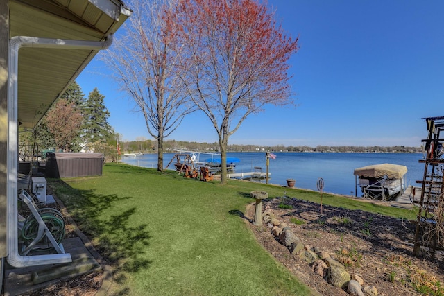view of yard featuring a water view and a dock