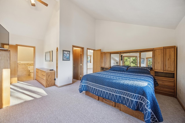 carpeted bedroom featuring high vaulted ceiling and baseboards