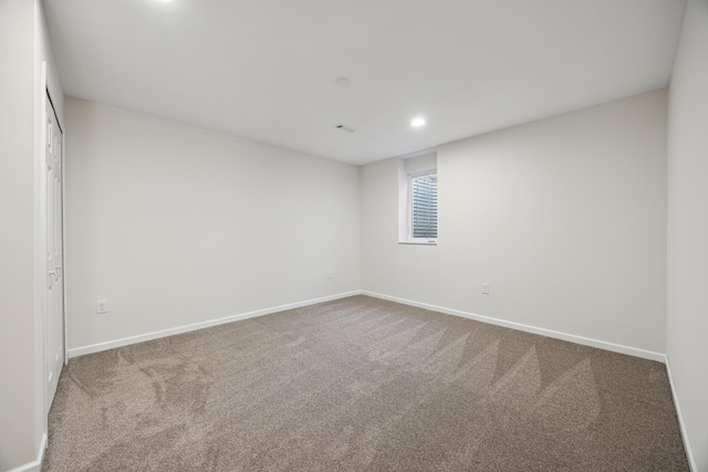 spare room with recessed lighting, carpet, and baseboards