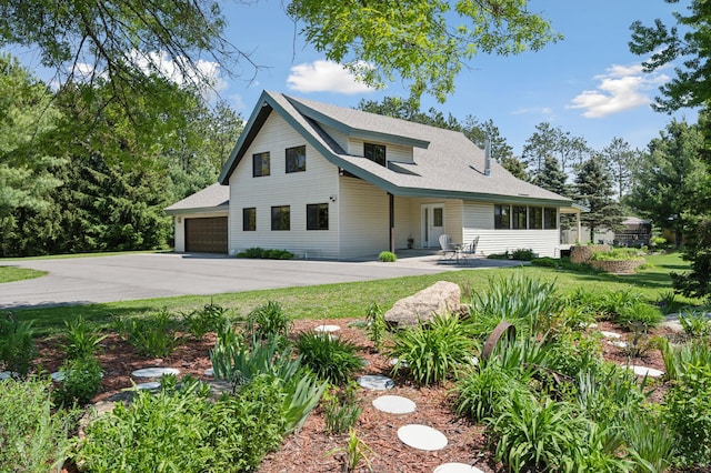 view of front facade with a front lawn and a patio area