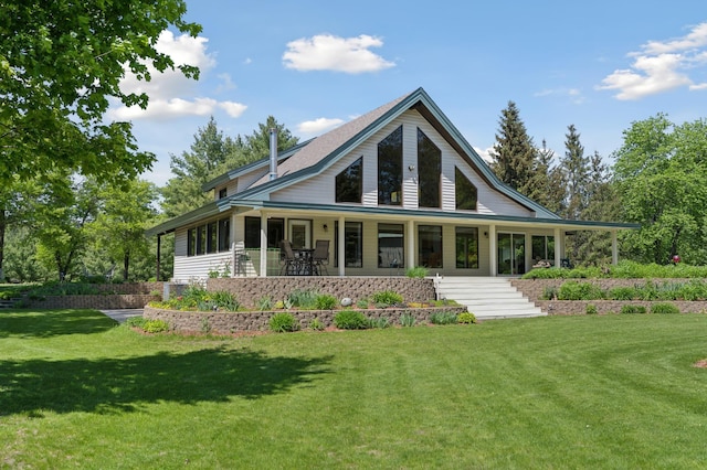 rear view of property with a lawn and a porch