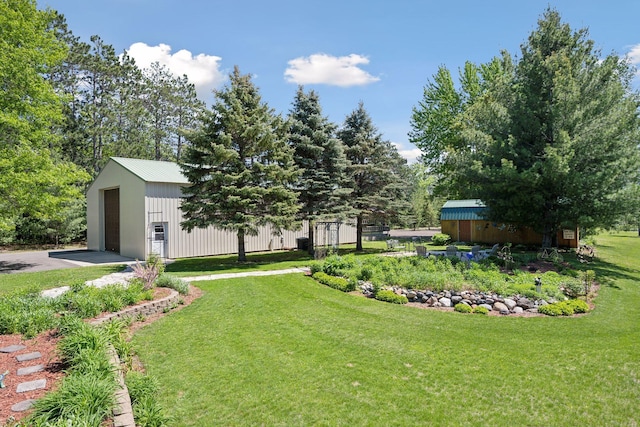 view of yard featuring an outbuilding and a detached garage