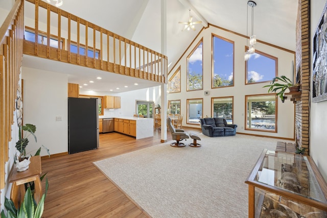 living room featuring light wood-type flooring and a high ceiling
