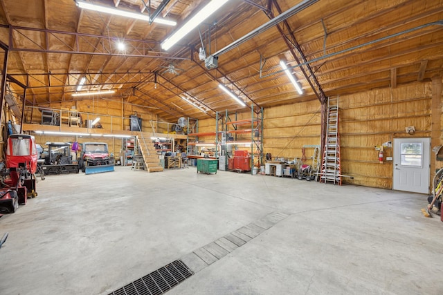 garage featuring a workshop area and wood walls