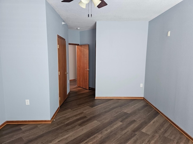 empty room featuring baseboards, a ceiling fan, and wood finished floors