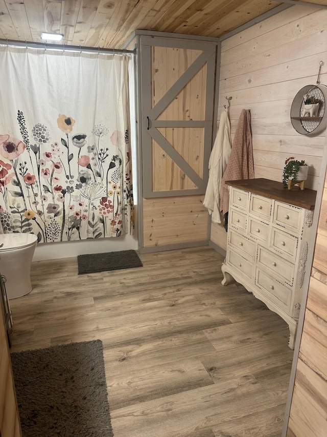 318 Pine Ave S, Sandstone, MN 55072 - interior space with a shower with curtain, wooden ceiling, wood finished floors, and wooden walls