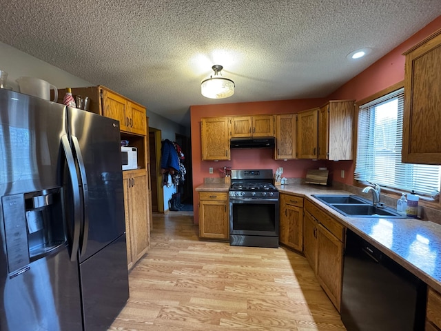 318 Pine Ave S, Sandstone, MN 55072 - kitchen featuring a sink, dishwasher, stainless steel fridge with ice dispenser, gas range oven, and under cabinet range hood