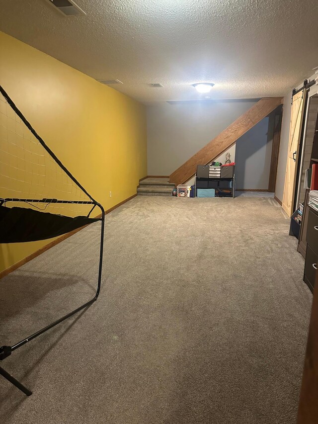 318 Pine Ave S, Sandstone, MN 55072 - finished basement featuring baseboards, a textured ceiling, and carpet