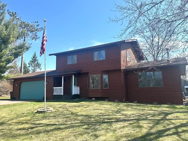 318 Pine Ave S, Sandstone, MN 55072 - view of front of home featuring concrete driveway, covered porch, a front yard, and a garage