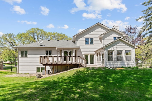 back of house with a wooden deck, a chimney, and central air condition unit