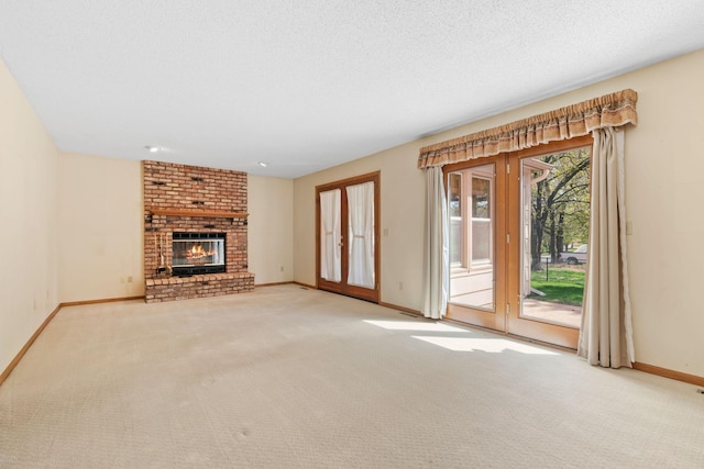 unfurnished living room with carpet, baseboards, and a brick fireplace