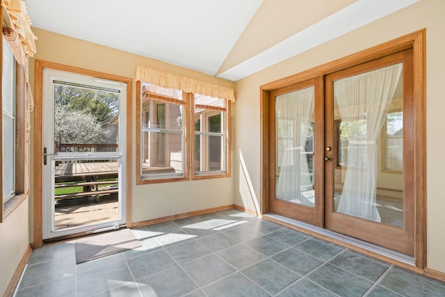doorway to outside featuring vaulted ceiling, baseboards, tile patterned flooring, and french doors