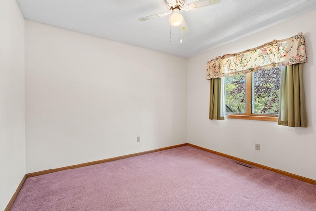 unfurnished room featuring carpet, baseboards, and a ceiling fan
