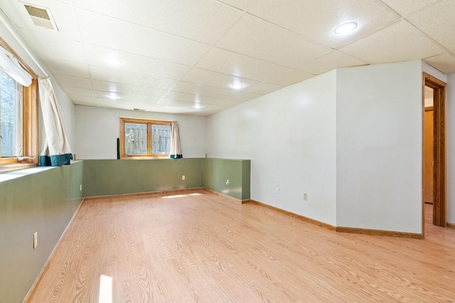 empty room featuring a paneled ceiling and wood finished floors