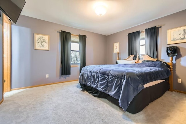 carpeted bedroom featuring baseboards
