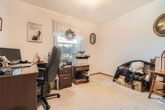 office with baseboards and light colored carpet