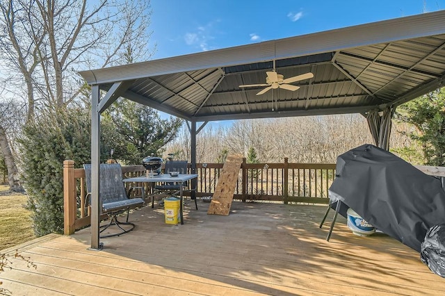 wooden deck featuring grilling area, a gazebo, and ceiling fan