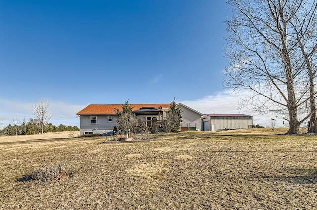 back of house with an outbuilding